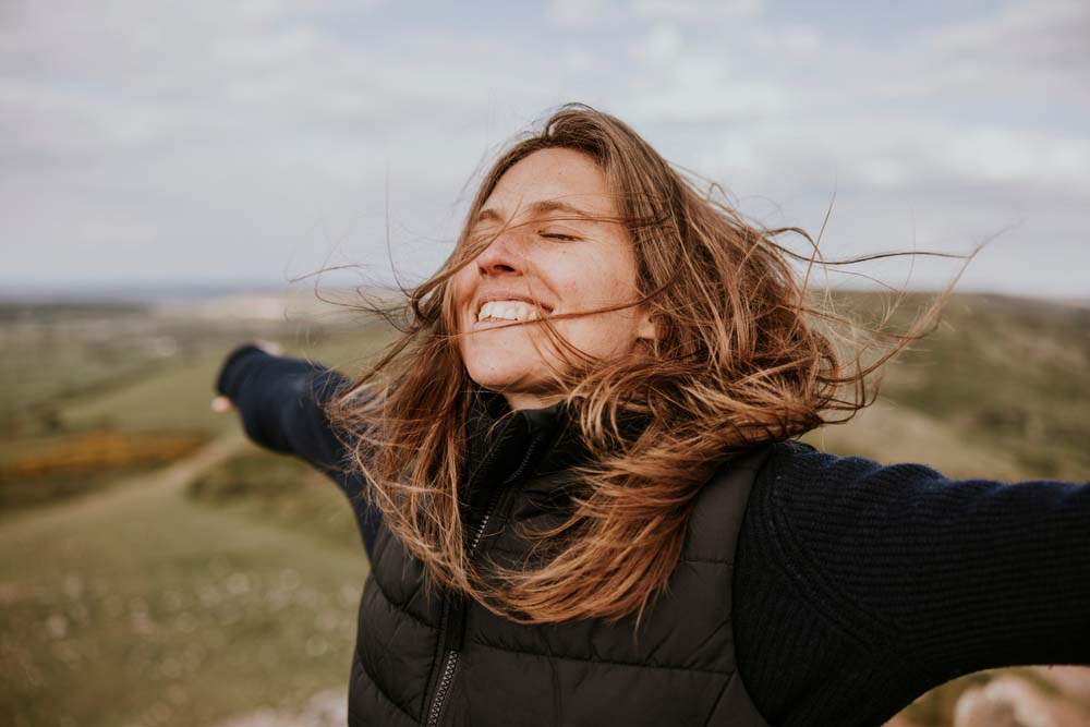 Happy woman outdoors with confident smile, highlighting Composite Fillings results