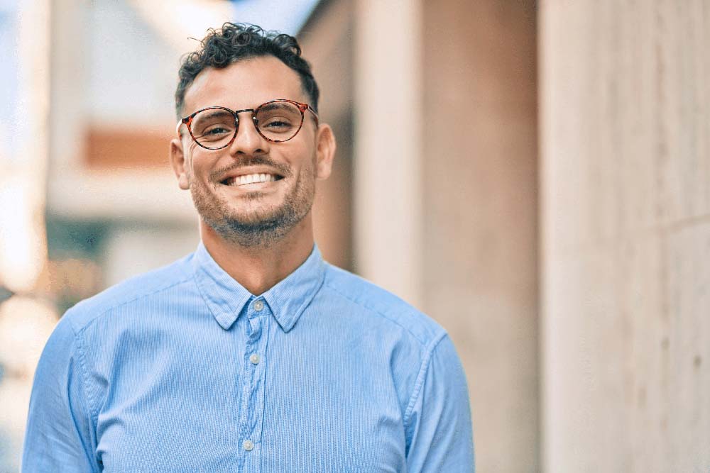 Smiling man with clear, healthy teeth after professional Crown Lengthening