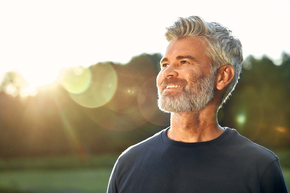 Confident man with healthy smile, highlighting long-term dental care results of Laser Dentistry