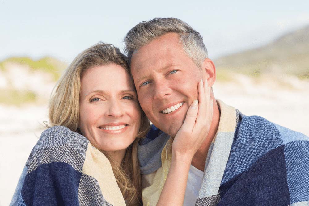Happy couple with healthy smiles, representing cosmetic dentistry in Jackson Hole