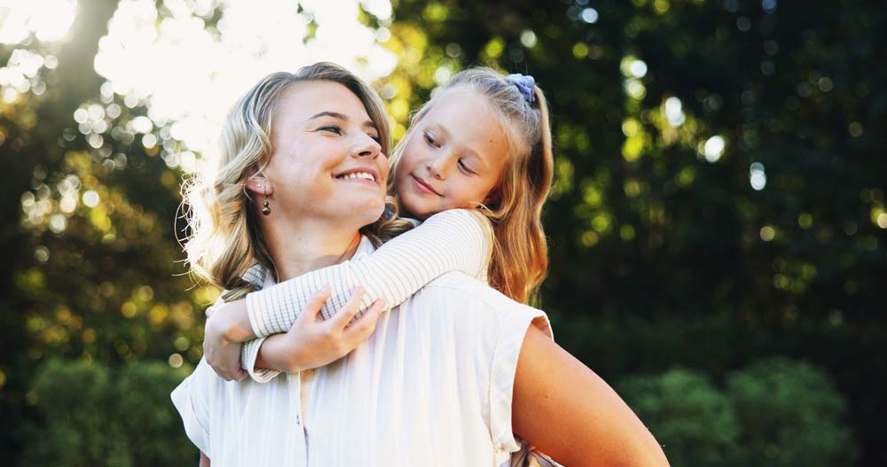 Mother and daughter smiling together, representing Oral Pathology care in Jackson Hole