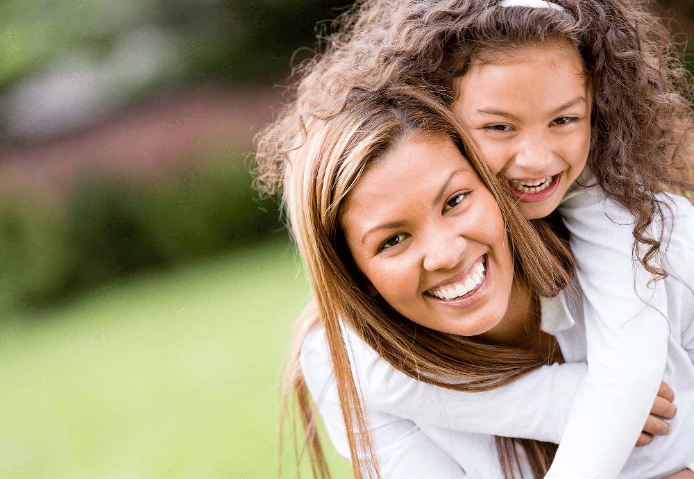 Happy mother and child with bright smiles, representing the benefits of Pediatric Dentistry in Jackson WY
