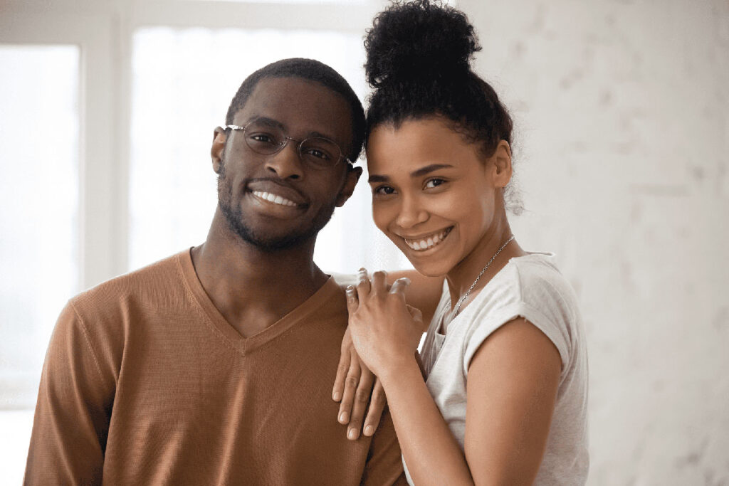 Smiling couple with bright teeth, showcasing confident smiles after Periodontal care