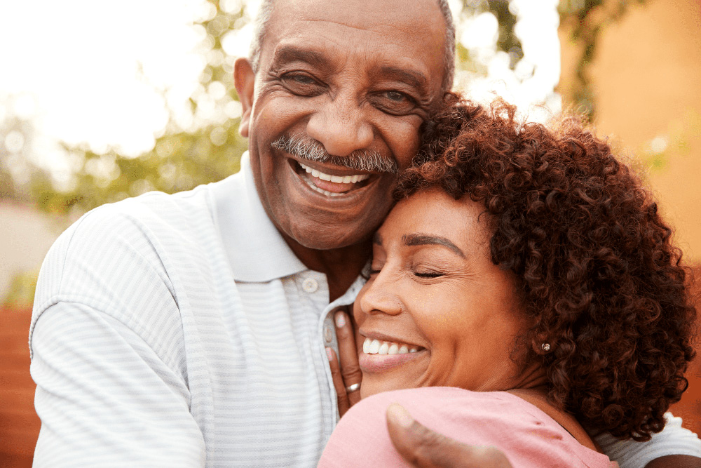 Happy couple with healthy smiles, showcasing cosmetic dentistry results