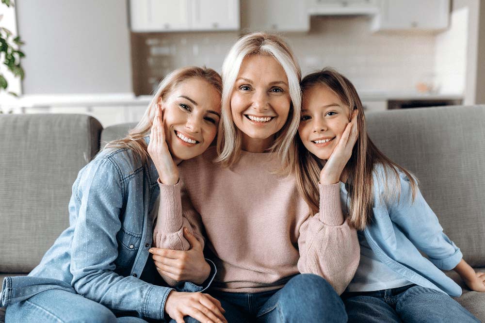 Happy family with children smiling, representing Prophylaxis (Teeth Cleaning) in Jackson Hole, WY