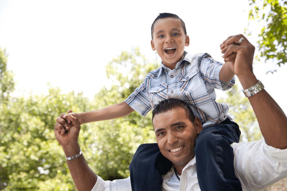 Father and child smiling together, representing family and Periodontal dental care in Jackson Hole