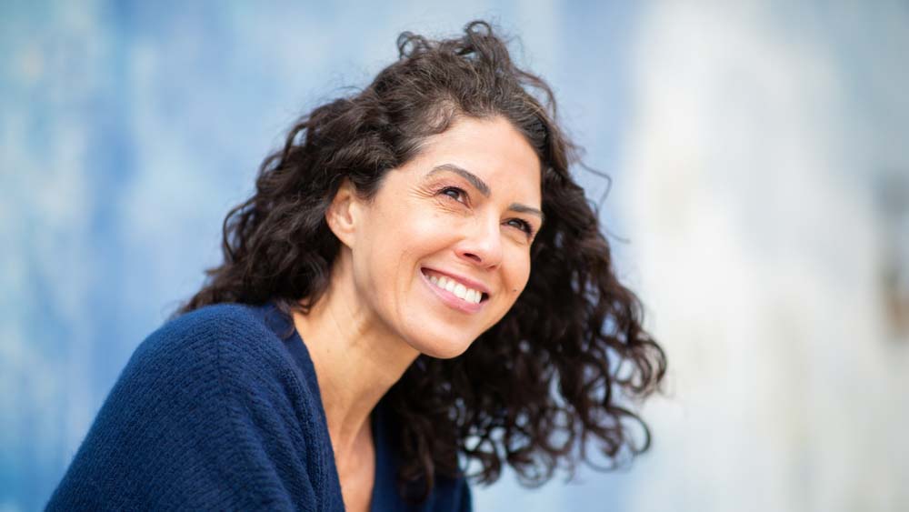 Confident woman smiling, representing TMJ (Tempro-Mandibular Joint Dysfunction) results in Jackson Hole